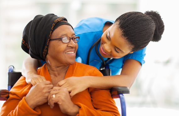 A smiling senior woman looking at her nurse with gratitude.