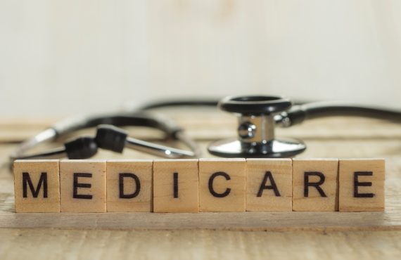 The word "Medicare" spelled out on a Scrabble board.