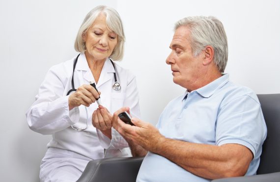 A nurse takes a man's blood during a doctor's visit, highlighting the importance of comprehensive healthcare with Medicare Advantage through Senior Healthcare Advisors.